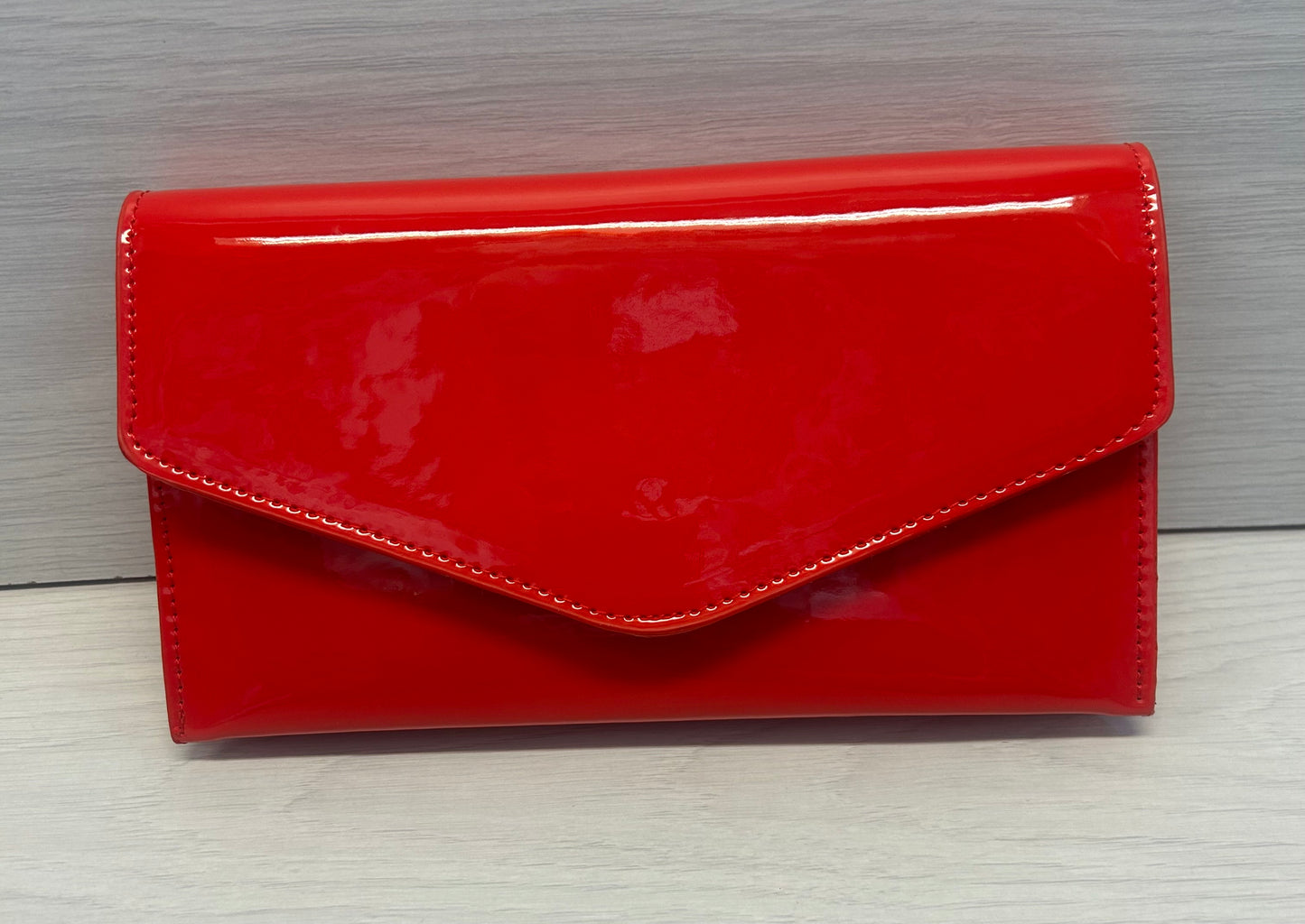 Red patent envelope clutch