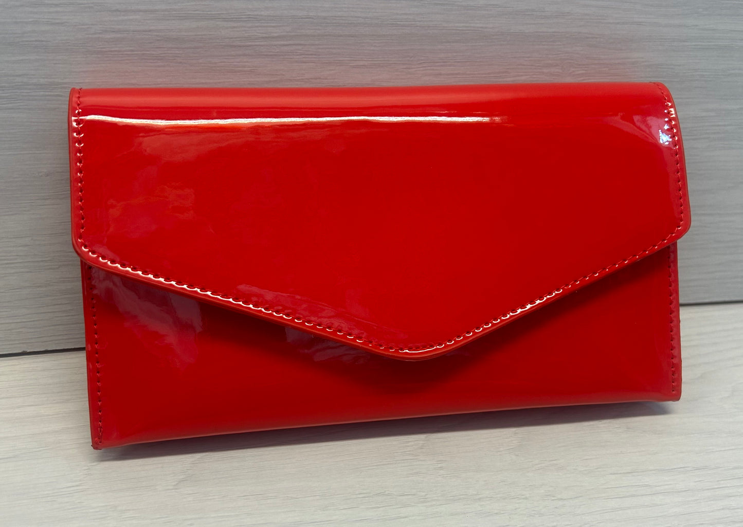 Red patent envelope clutch
